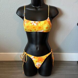 Orange floral triangl top with string bottom swimsuit set.